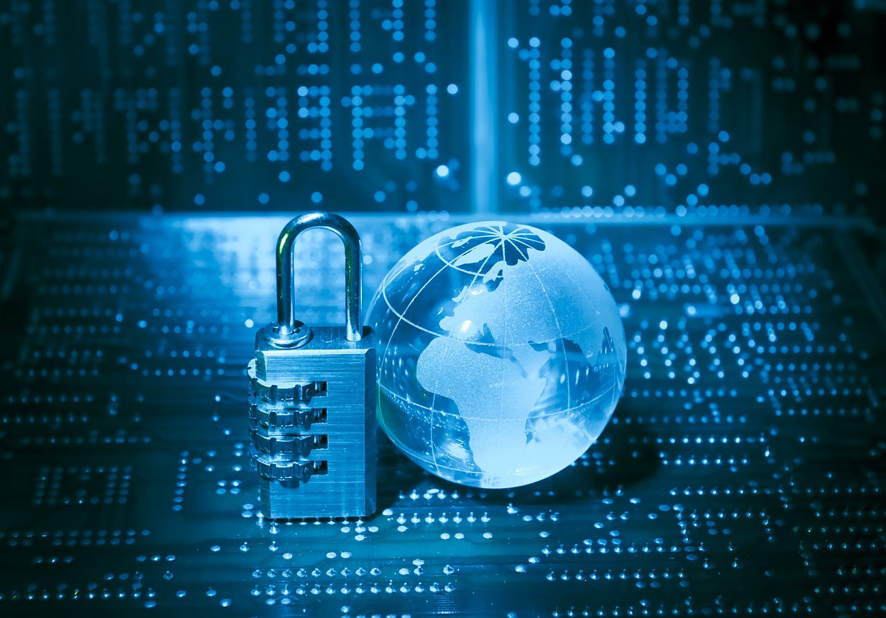 Combination-lock padlock and glass globe on a circuit board symbolizing global cybersecurity.
